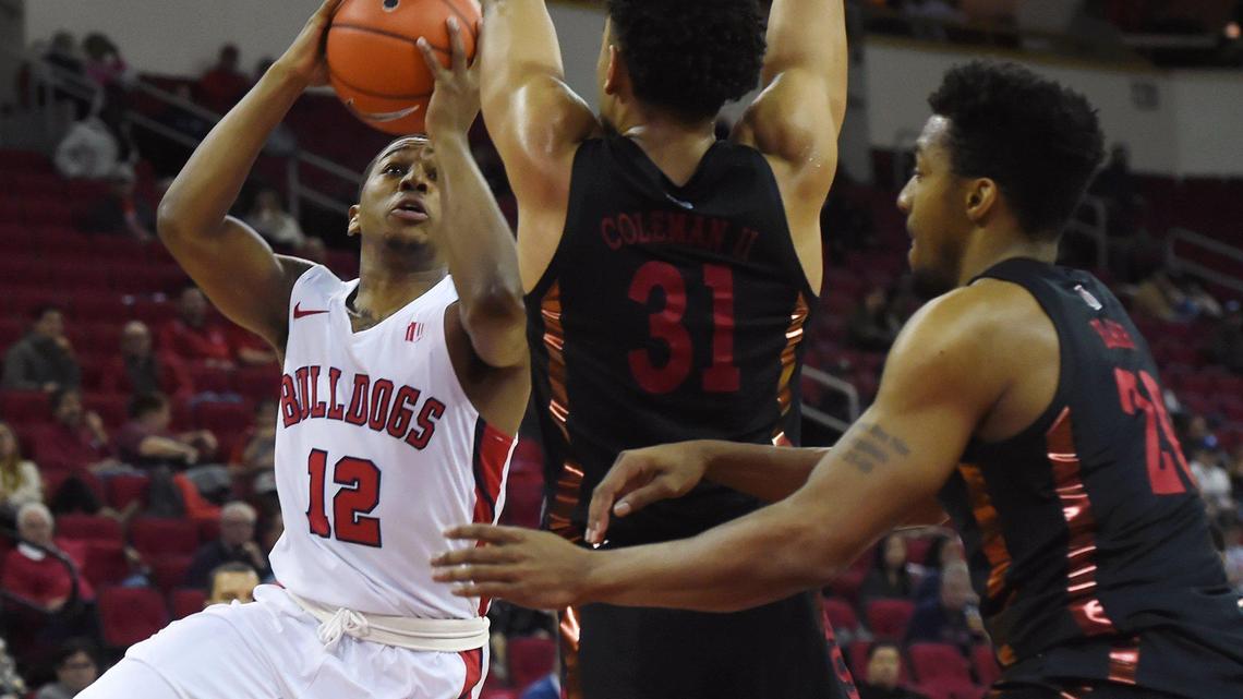 Fresno State guard Mustafa Lawrence, left, goes up for a shot against UNLV’s Marvin Coleman, center, and Nick Blair, right, in the Bulldogs’ 81-80 double overtime loss in their Mountain West opener Wednesday, Dec. 4, 2019 in Fresno. Lawrence scored 16 points and had five assists in just 21 minutes.