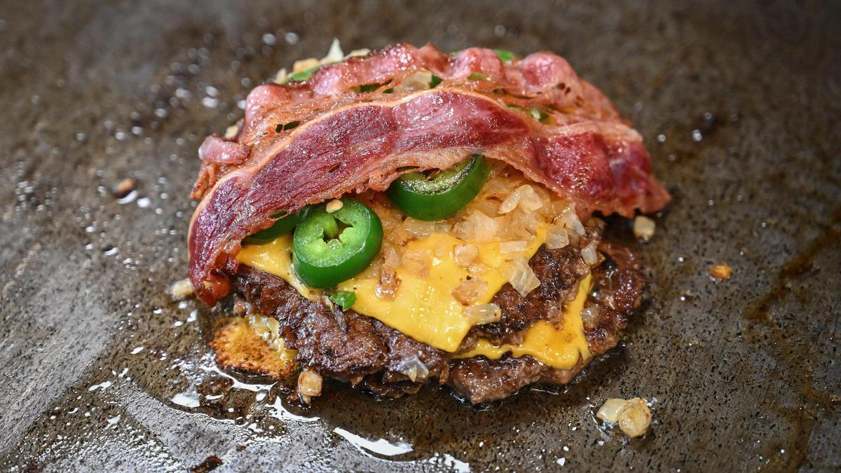“The Main,” Main Street Burgers’ signature burger, features two smash burger patties, cheese, grilled onions and jalapeños and bacon.