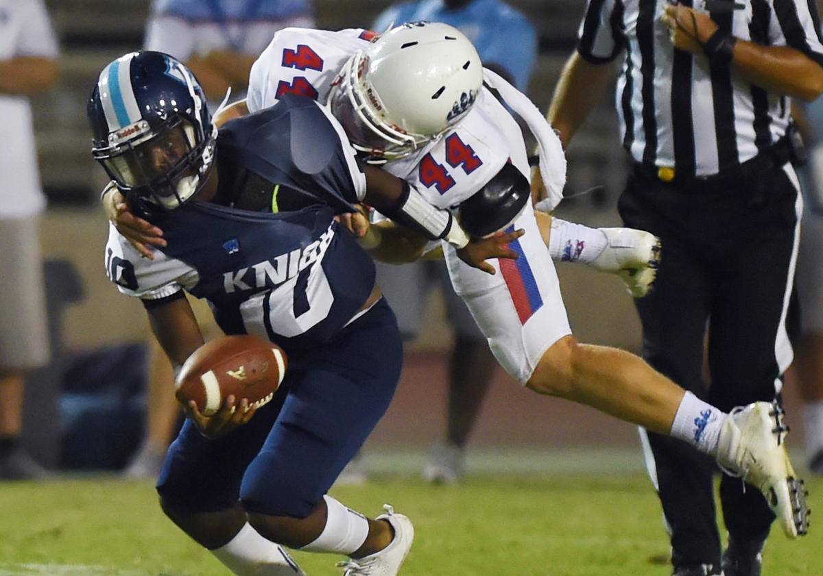 Bullard’s quarterback Vincent Andrews, left, is sacked at Ratcliffe Stadium Friday, Aug. 24, 2018 in Fresno. Buchanan shut-out Bullard 31-0.