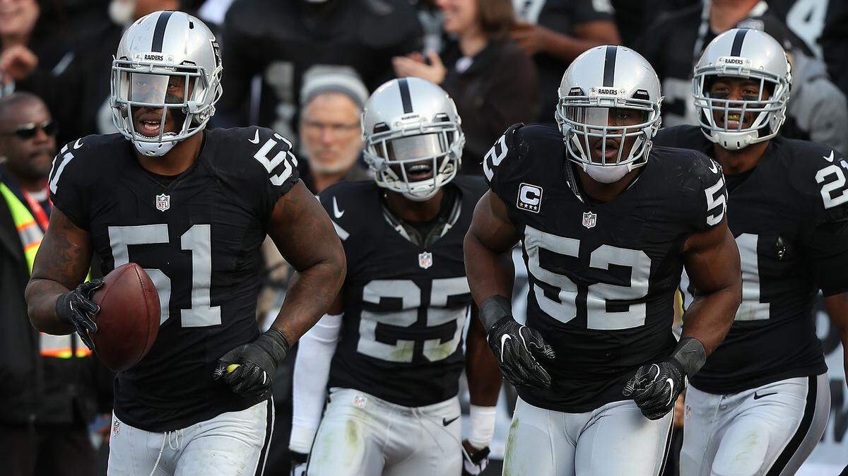 Bruce Irvin (51) and Khalil Mack (52) lead the Raiders defense during action against the Carolina Panthers during an NFL game Sunday, Nov. 27, 2016, in Oakland, CA.  Irvin will play his natural  position defensive end this season on the opposite side of Mack. Mack is holding out because of a contract dispute..