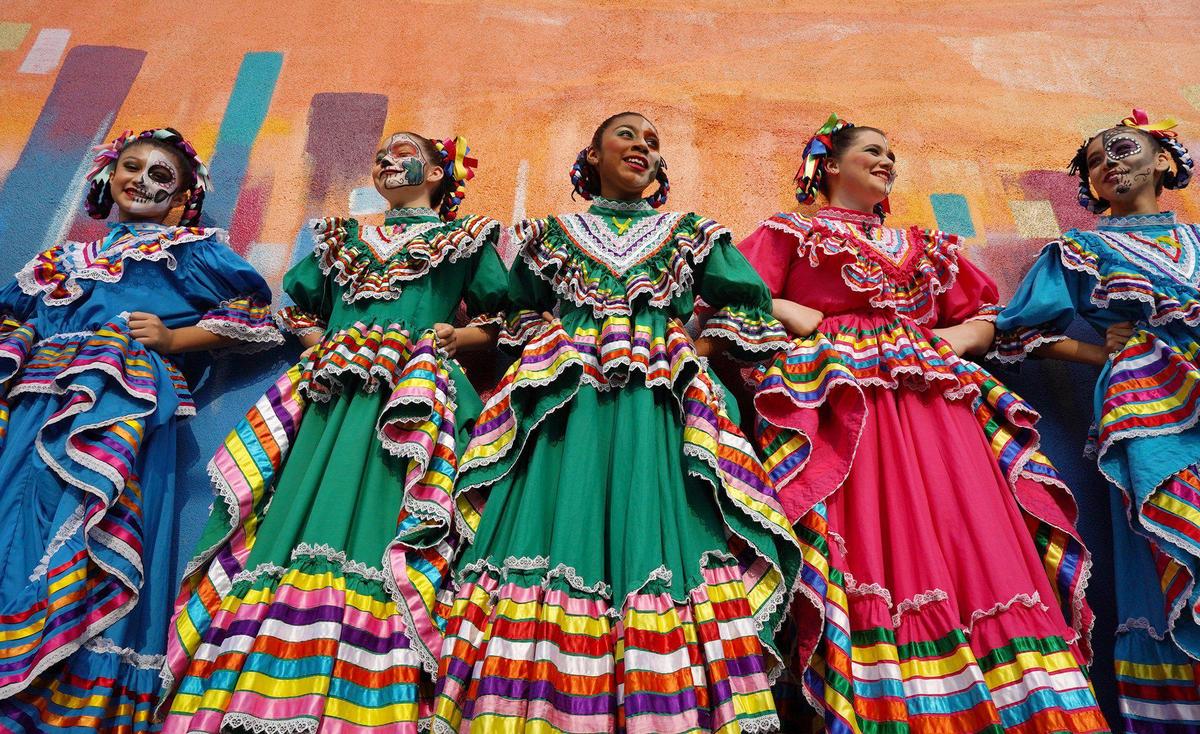 Dancers with Los Ninos Azteca prepare to perform for hundreds at Arte Americas annual Cala Gala event celebrating Día de los Muertos Saturday, Oct. 30, 2021 in Fresno.