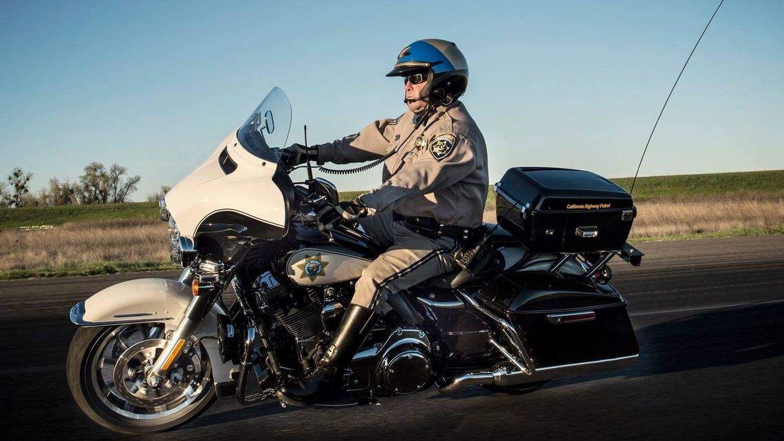 A CHP motorcycle officer takes off with proper safety clothing and gear.