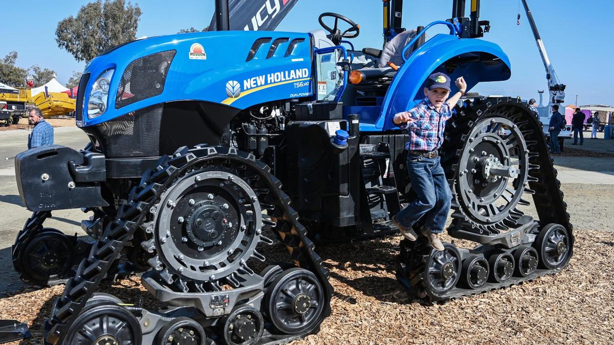 Anson Rahe, 6, of Cuyama Valley hops off a tractor while visiting the World Ag Expo in Tulare with his family on Tuesday, Feb. 8, 2022.