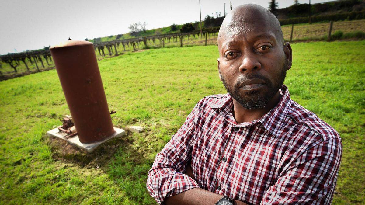 JePahl White stands on the property where his father’s west Fresno home once stood, with the long-shut down well in background and an old vineyard. By the age of 42, White had endured two kidney transplants, surgery for a cancerous tumor and open-heart surgery. He blames the dirty air and contaminated water found in west Fresno, which is where many of the city’s African Americans live.