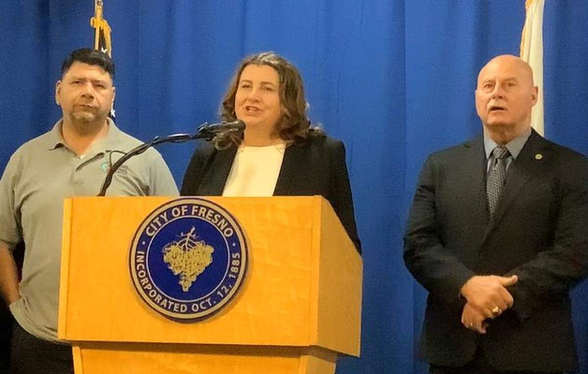 Fresno City Manager Georgeanne White, center, addresses reporters during a press conference with City of Fresno Professional Employees Association president Jesse Gonzalez, left, and Mayor Jerry Dyer, right, at Fresno City Hall on Wednesday, Dec. 18, to announce a tentative contract agreement between the city of Fresno and the association, which represents white-collar workers across a range of city departments.