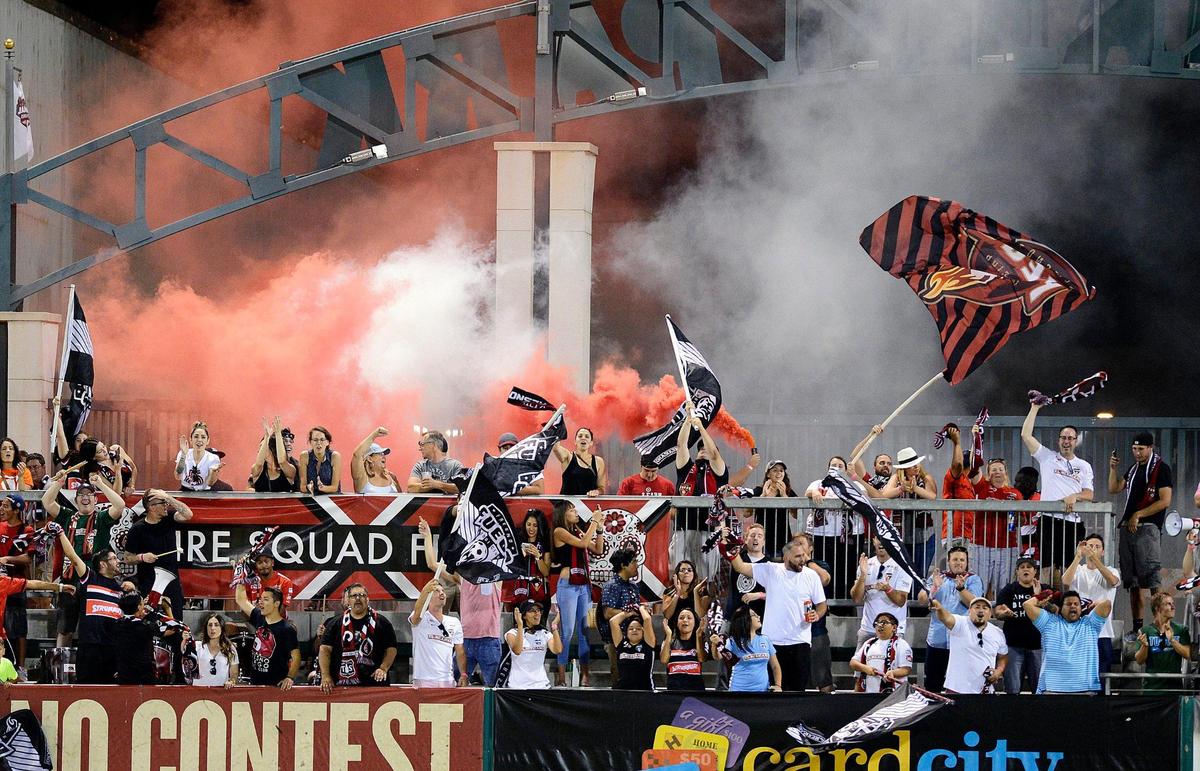 Fresno Fire Squad fan club members celebrate a late-game goal against Burlingame in their playoff match at Chukchansi Park, Tuesday, July 19, 2016.