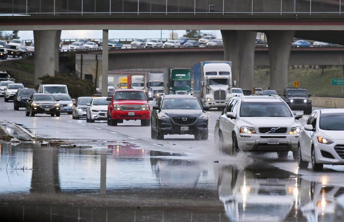 Southbound 41 traffic backs up as it merges with southbound 99 near Church Avenue after a black Honda SUV crashed in a flooded portion of the freeway blocking the outside lane Wednesday, March 10, 2021 in Fresno.