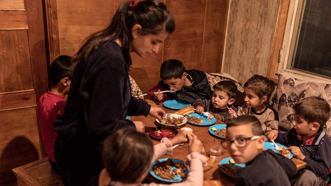 Five Armenian families, who fled Nagorno-Karabakh following the Azeri offensive, are seen settled in a house given to them by a neighbor in the town of Goris until they find a new home.