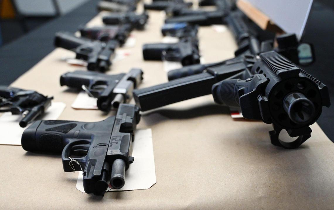 Confiscated firearms are seen following a joint press conference announcing the results of a 5-month long investigation into street gangs called No Fly Zone on Friday afternoon, April 15, 2022 in Fresno.