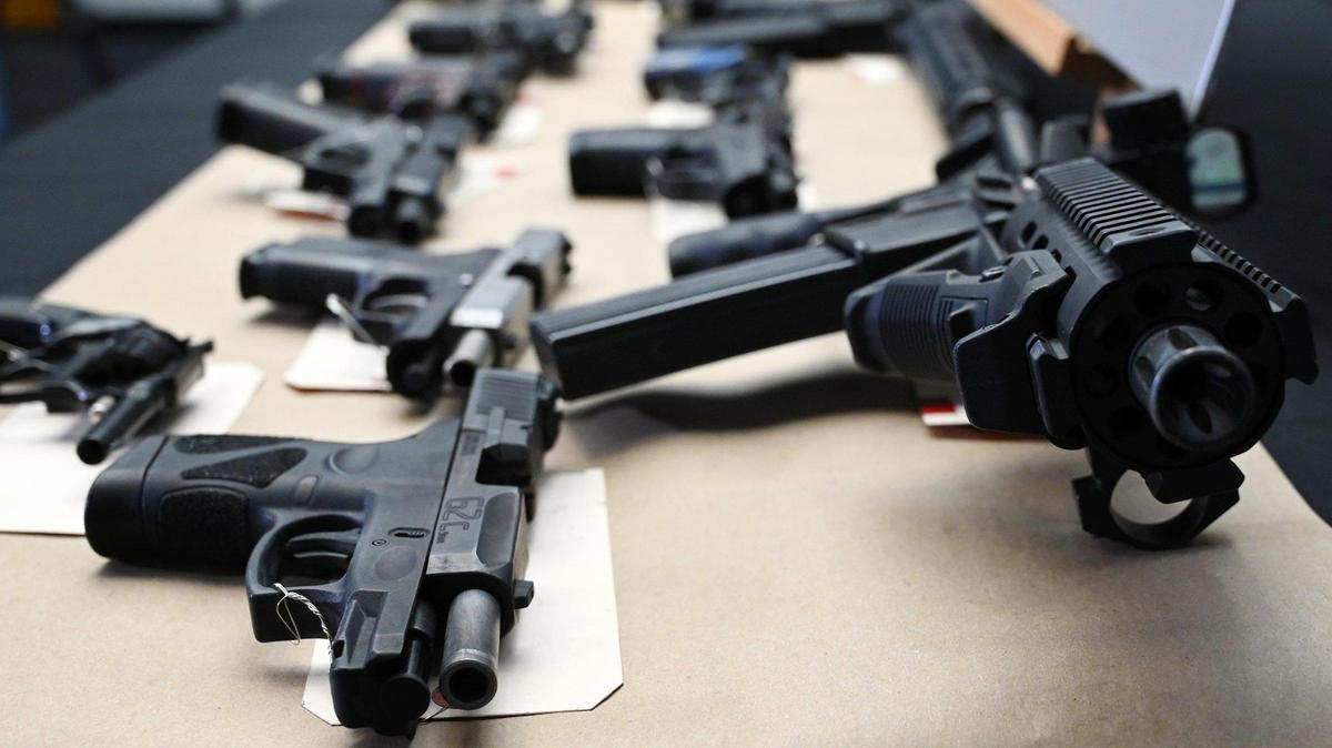 Confiscated firearms are seen following a joint press conference announcing the results of a 5-month long investigation into street gangs called No Fly Zone on Friday afternoon, April 15, 2022 in Fresno.