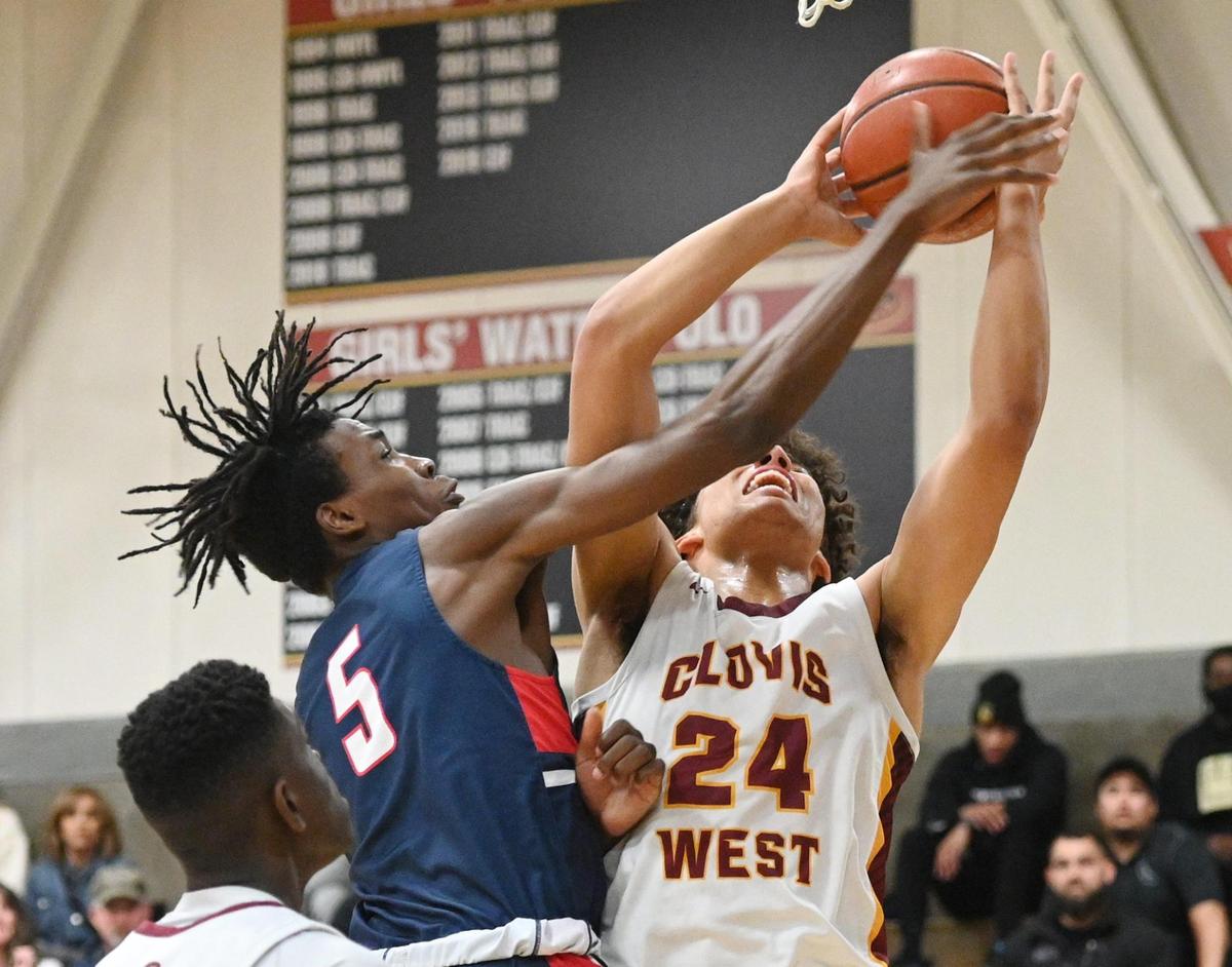 Clovis West’s Tyus Parrish-Tillman, right goes to the hoop while contested by Modesto Christian (player unidentified, not on roster) during their NorCal Open Division boys basketball semifinal at Clovis West on Saturday, March 5, 2022.