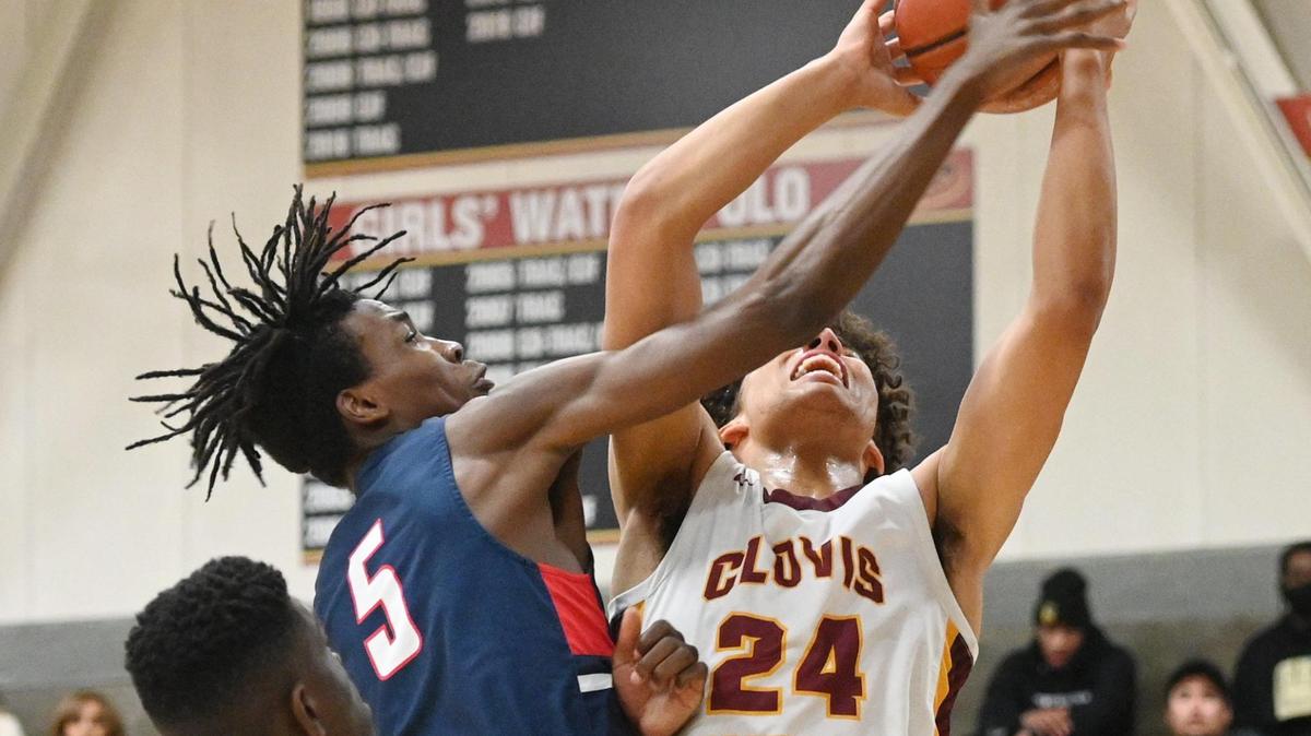 Clovis West’s Tyus Parrish-Tillman, right goes to the hoop while contested by Modesto Christian (player unidentified, not on roster) during their NorCal Open Division boys basketball semifinal at Clovis West on Saturday, March 5, 2022.