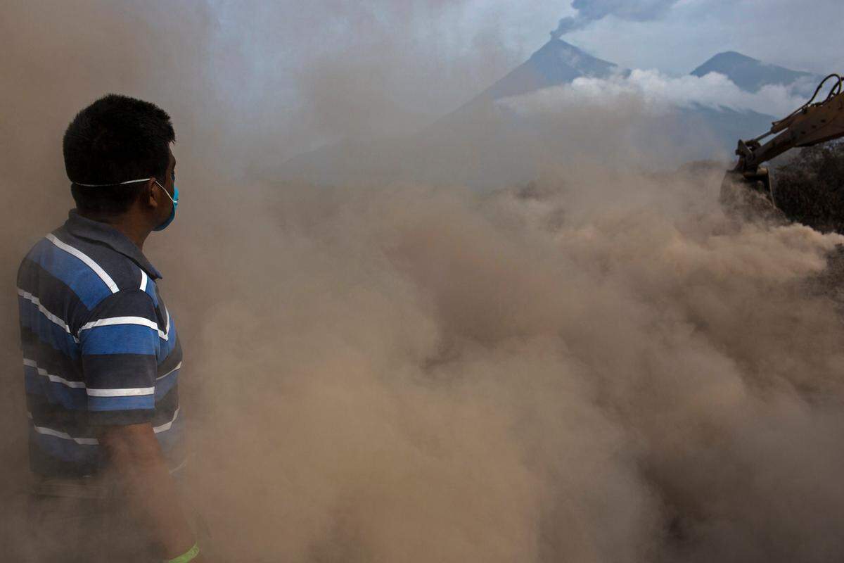 Elmer Vazquez stands amid volcanic ash and dust as he searches for the remains of his wife and five children who were killed by the Volcano of Fire at his home buried in volcanic ash in San Miguel Los Lotes, Guatemala, on June 14, 2018.