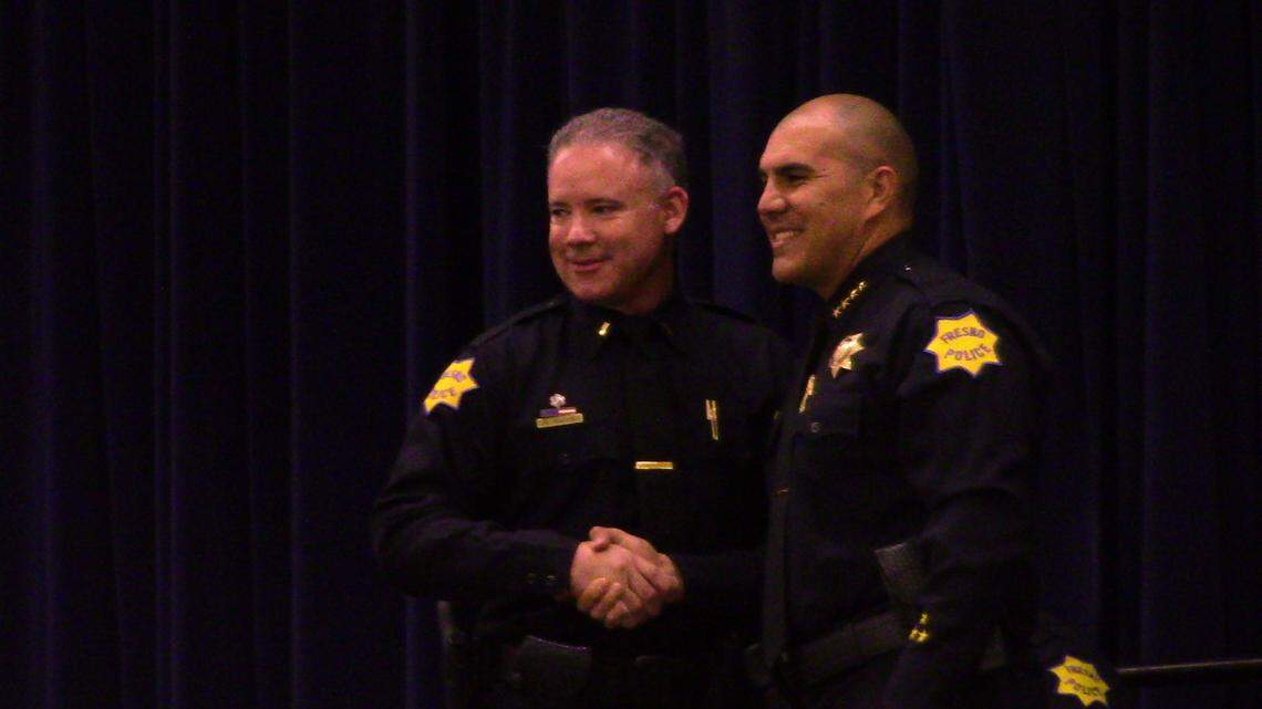 Brian Valles is congratulated by Fresno Police Chief Paco Balderrama after he was promoted to lieutenant on Tuesday, Aug. 10, 2021.