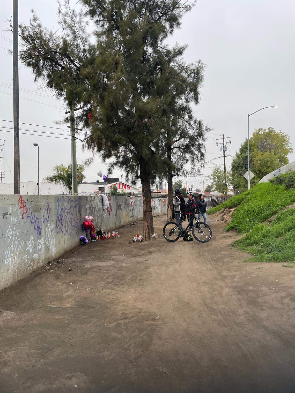 Homeless advocates and friends of Denise Celis and Ronald Wallace gather at a memorial where the pair was found dead on Friday, Dec. 12, 2025.