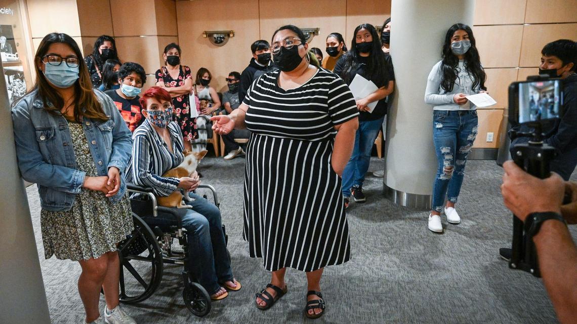 Faith in the Valley community organizer Alexandra Alvarado, center, stands in the lobby of the City of Fresno council offices at City Hall while pleading with staff members to have any city leader come out and hear Trails End Mobile Home Park residents and their children who are asking for help in blocking the sale of the park to Harmony Communities, on Tuesday, April 5, 2022. In the end a staff member with Councilmember Nelson Esparza’s office came out to listen to the children.
