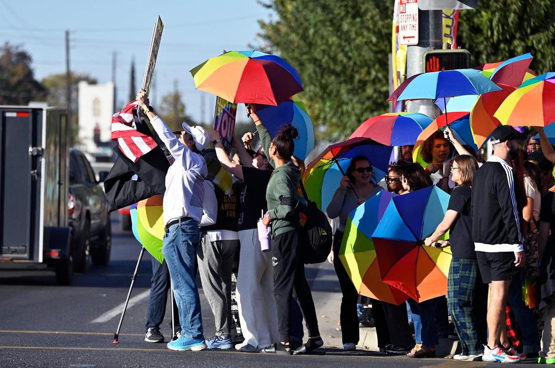Supporters of a coalition of LGBTQ+ organizations, right, follow members of a group from Westboro Baptist Church, left, across the street from Roosevelt High School Monday, Oct. 28, 2024, Fresno.
