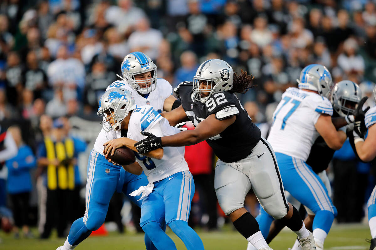 Detroit Lions quarterback Matt Cassel, left, is sacked by Oakland Raiders nose tackle P.J. Hall (92) during the first half of an NFL preseason football game in Oakland, Calif., Friday, Aug. 10, 2018.