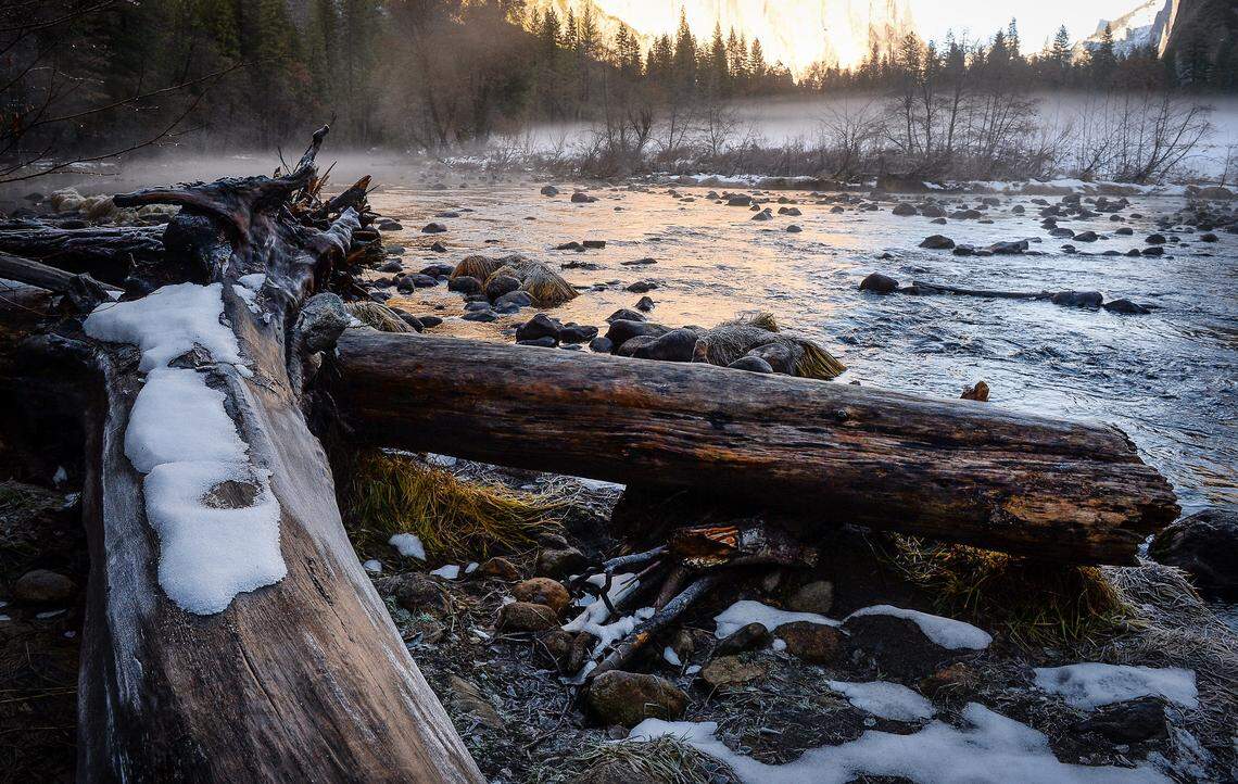 Light snow, ice and fog are visible near the Merced River in Yosemite Valley after snow dusted the area over a few days, on Monday, Dec. 9, 2019.