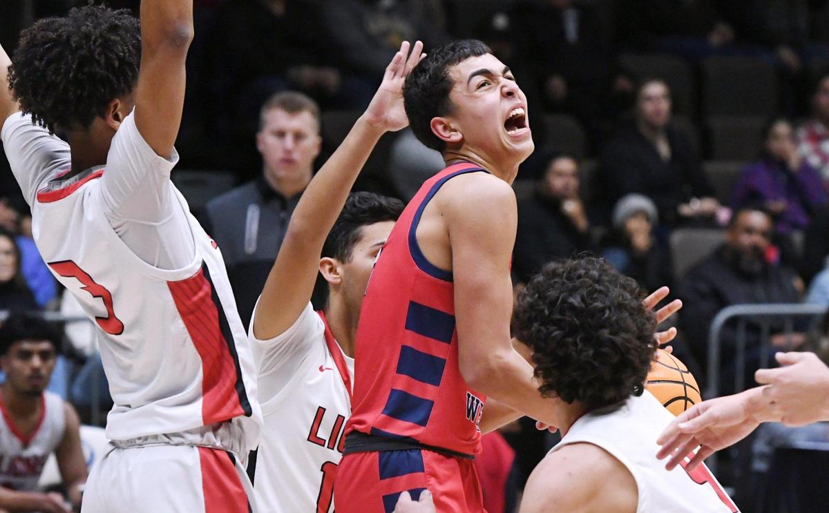Tulare Western’s Malachi Ficher, center, struggles to control the ball against Kerma at the CIF Central Section Division IV basketball championship Friday, Feb. 24, 2023 in Fresno.