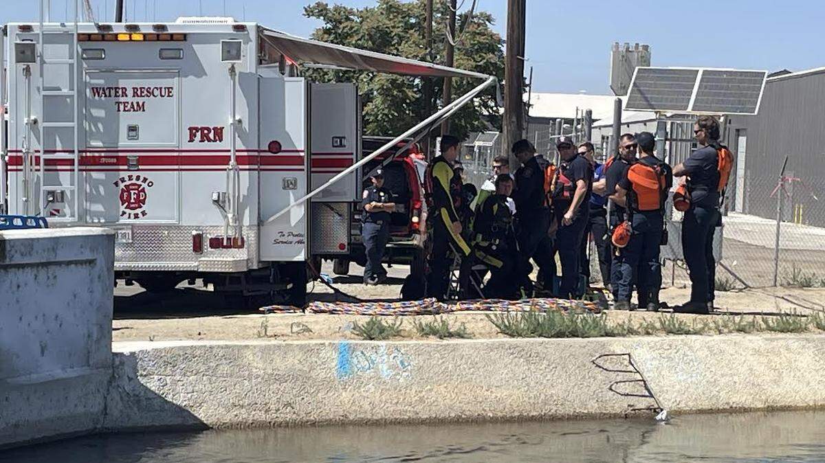 A Fresno Fire Department water rescue team prepares to search a stretch of canal near Thorne and Nielsen avenues in southwest Fresno.