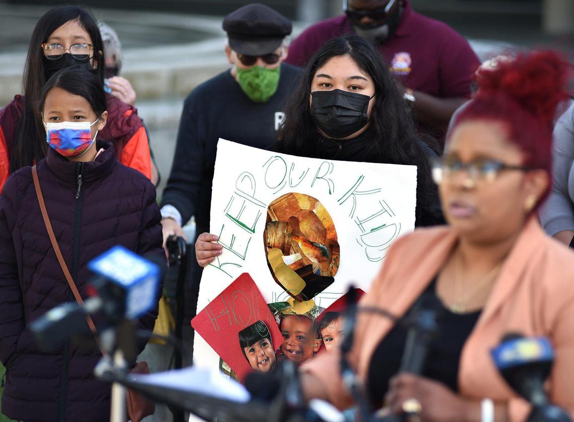 A young person holds a sign reading “Keep Our Children Housed,” as Inez Hernandez, a mother of four who was recently evicted from the Manchester Arms apartment complex, speaks during a press conference at City Hall, April 8, 2021, held by the Right to Counsel coalition. The coalition, is seeking help in implementing legal support and protection for renters, who face evictions, unsafe living conditions, and other problems. The coalition, with the Leadership Counsel for Justice and Accountability,&nbsp;Faith in the Valley,&nbsp;students from Fresno State, faith leaders, and people who have been evicted.