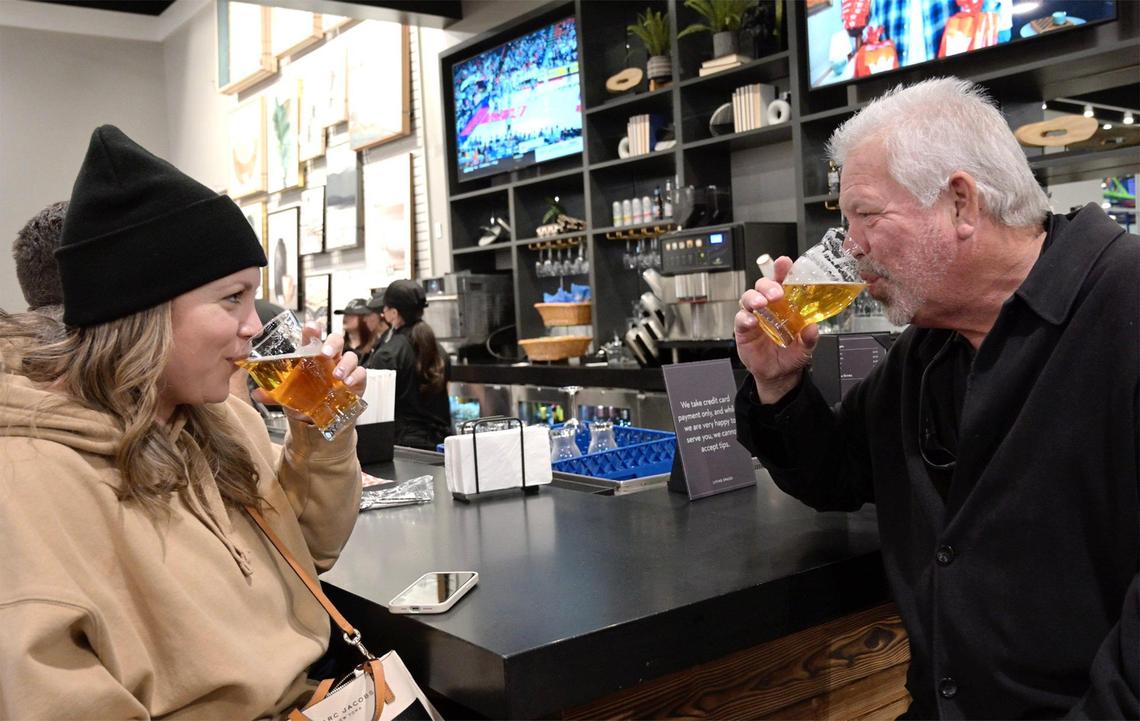 Steph Hubbard, left, shares a beer with her father Chris Hubbard, right, during the Friends & Family night for Living Spaces, a new furniture store Wednesday, Feb. 5, 2025 in Fresno. The expansive showroom includes a childrens play area and cafe serving family-friendly food plus beer and wine for adults. The new furniture store observes its grand opening 10am Friday morning, Feb. 7, 2025.