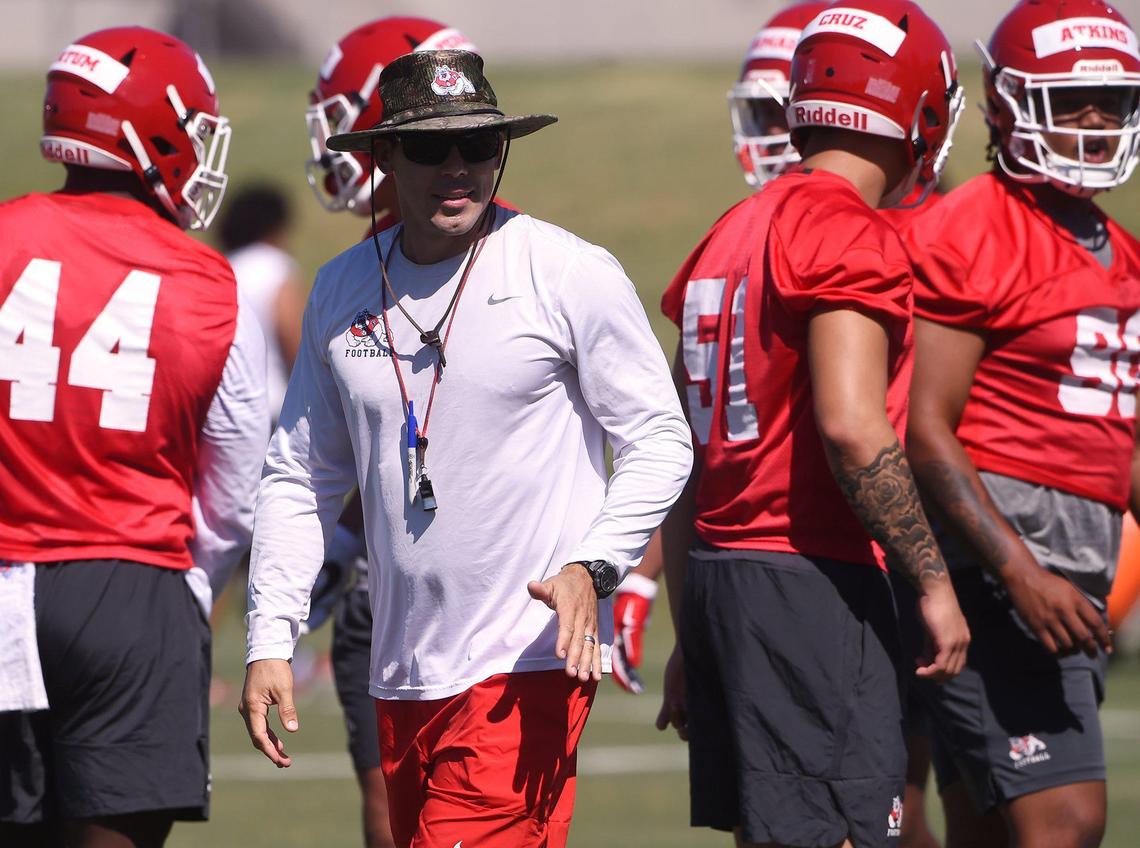 Fresno State defensive coordinator Bert Watts, center, watches a drill on the first day of preseason camp Friday, Aug. 2, 2019.