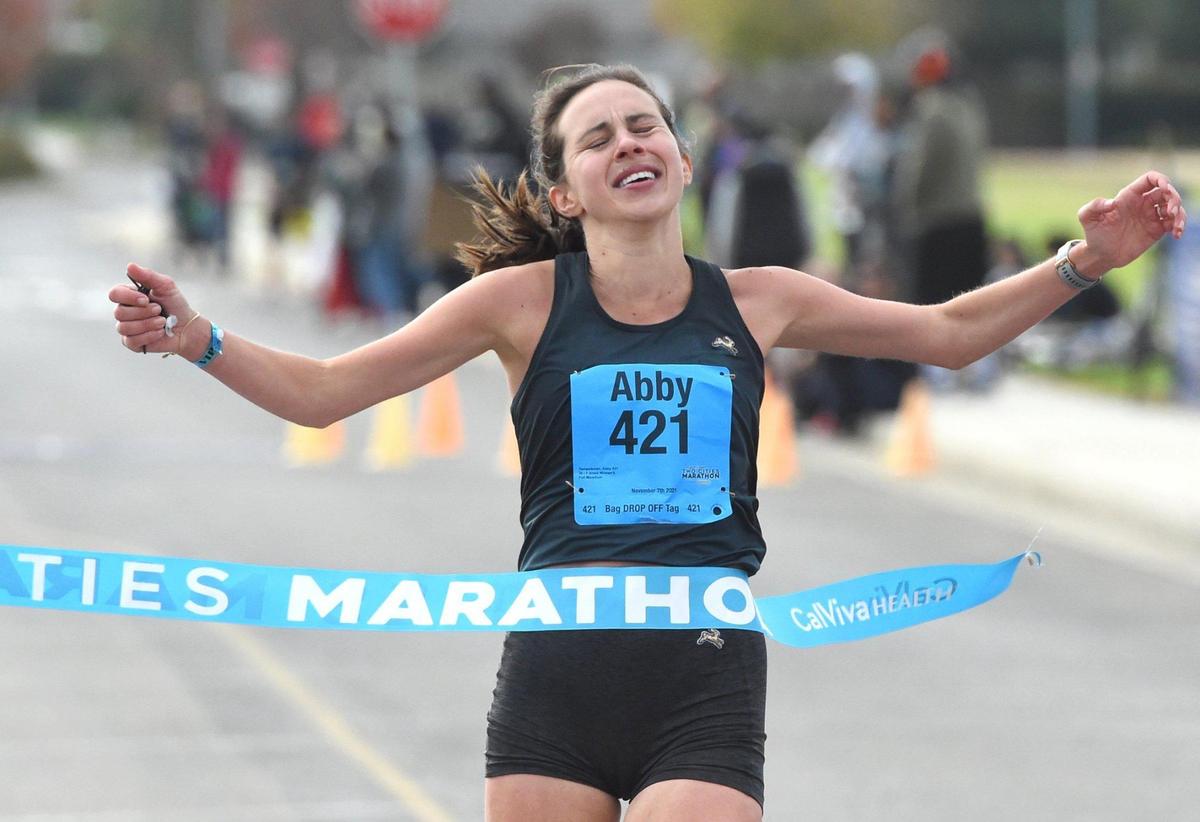 Abby Tempelsman of San Francisco crosses the finish Sunday, Nov. 7, 2021, as the first female to complete the full marathon of the Two Cities Marathon at Clovis Community College.