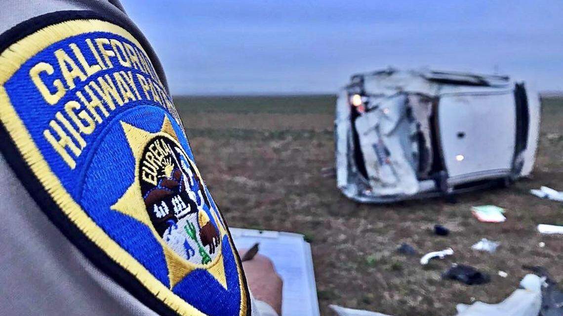A CHP officer investigates a vehicle crash in Kern County.
