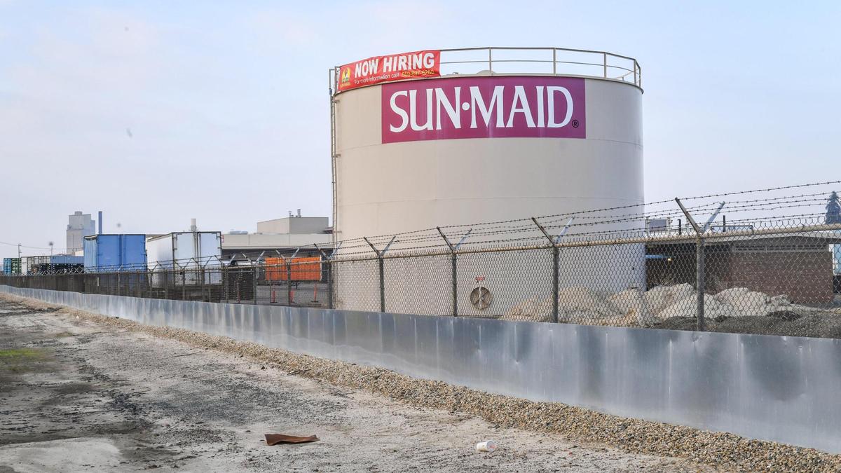 The Sun-Maid Raisin factory is shown at its location along Highway 99 on Wednesday, Nov. 11, 2021. Kingsburg resident Doug Johnson lives next door to the factory which he says dumped a massive amount of waste water into a bordering drainage canal that filled it with a black sludge.