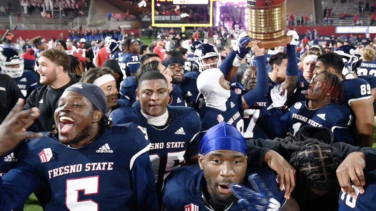 The Fresno State football team celebrates its 32-28 win over San Diego State, pulling ahead in the final minutes to win the Old Oil Can Saturday, Oct. 29, 2022 in Fresno.