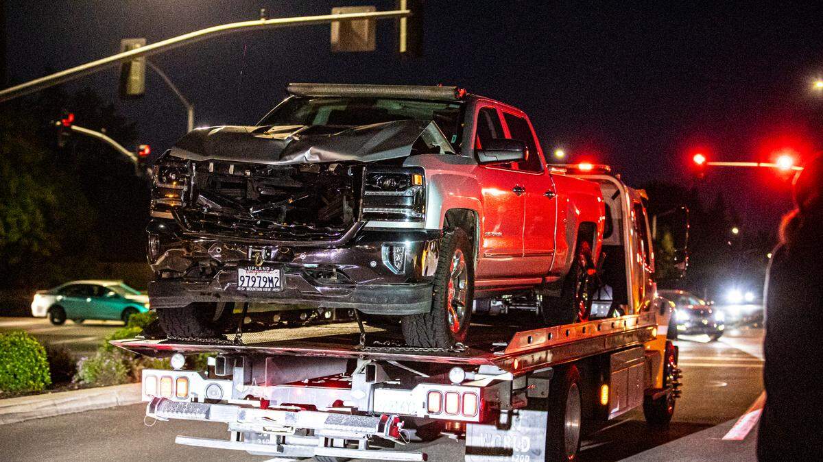 A tow truck drives a truck involved in a fatal hit-and-run out of an apartment complex on Friday, May 13, 2022. The driver of the truck hit and killed a 29-year-old woman, dragging her 8 miles through Fresno.