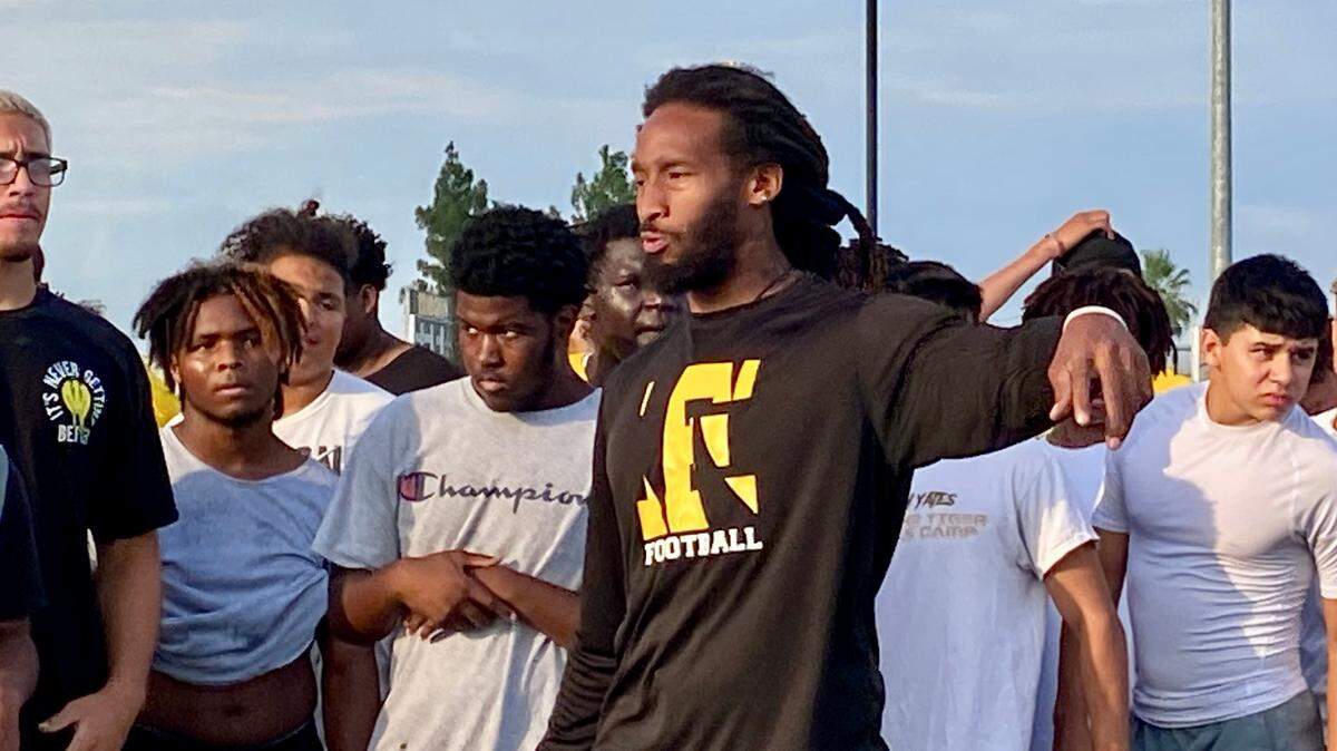 Edison High football coach Johnny Sears Jr. instructs his team during workouts.