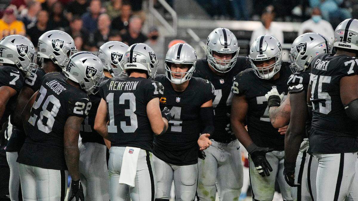 Las Vegas Raiders quarterback Derek Carr huddles with teammates in the second half of their game against the Washington Football Team on Sunday, Dec. 5, 2021, in Las Vegas.