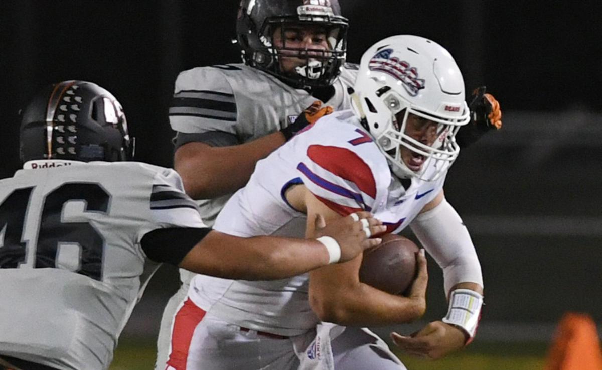 Buchanan quarterback Jayden Mandal squeezes through Central’s defense on a carry Friday, Oct. 7, 2022 in Fresno. Buchanan won 49-41.