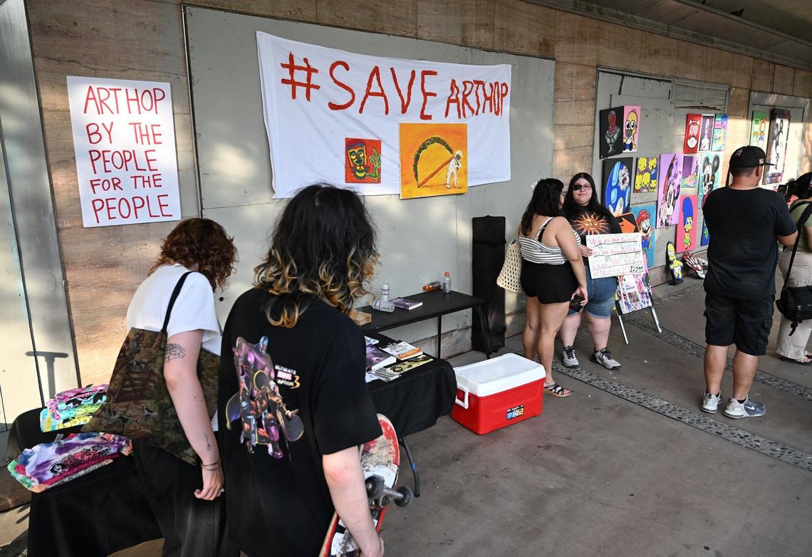 Vendors selling art and more work from tables along Fulton Street during a small protest against the city’s decision to prohibit vendors during ArtHop Thursday, Aug. 1, 2024 in downtown Fresno.