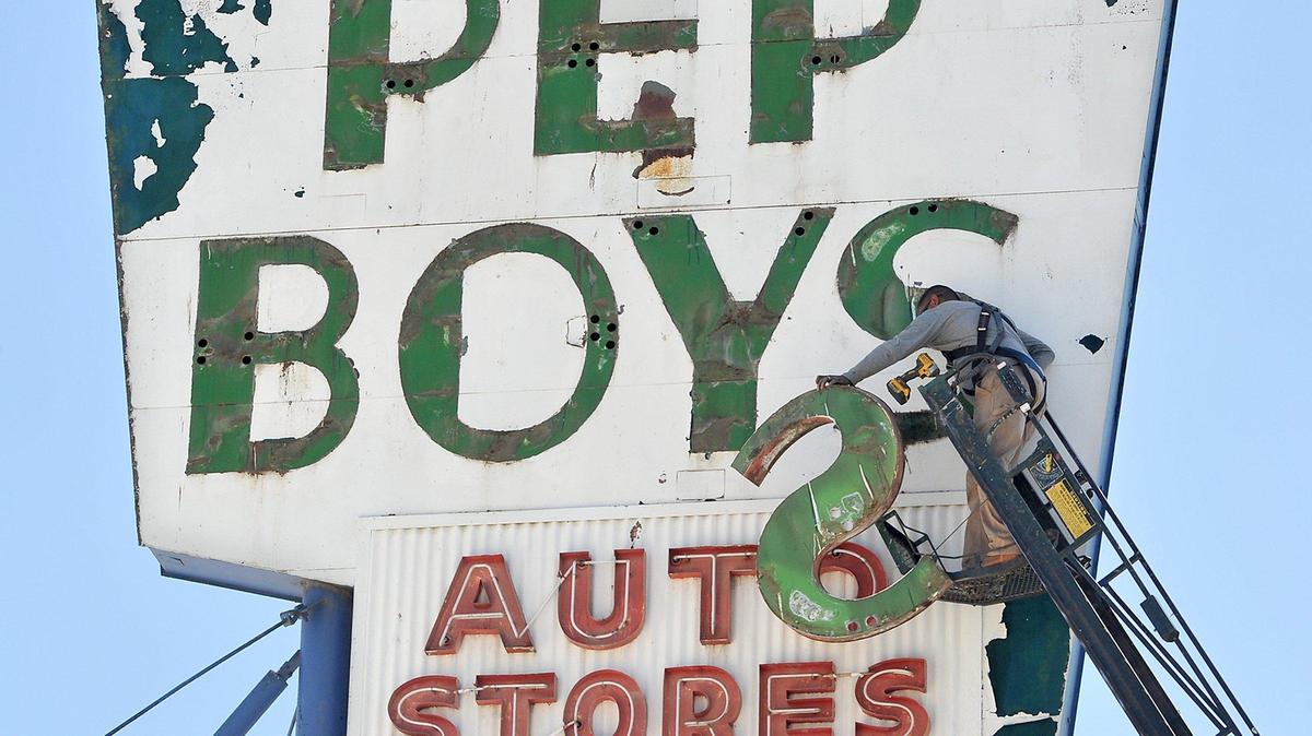 Anthony Avina of The Sign Guys from Merced gets set to drop the metal ’S’ that held neon, during dismantling of the iconic Pep Boys sign at the closed auto business, at 716 Broadway in downtown Fresno, May 20, 2020. Pep Boys had been in operation since 1948 at this location, which is permanently closed. The metal letters were taken down, so that the main structure of the sign can be painted over, once a new tenant moves in.