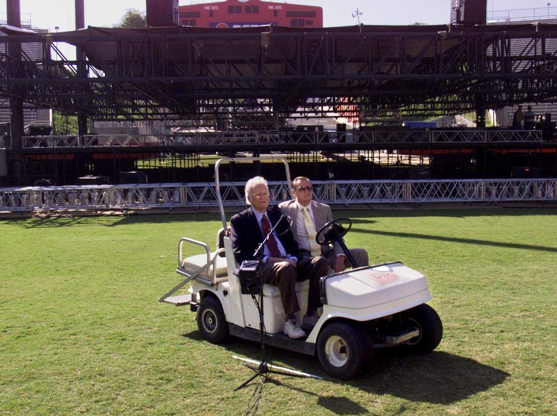 Elmer “Bud” Richter was chairman of the Fresno Crusade when the Billy Graham Crusade stopped in Fresno Oct. 11-14, 2001. Here Graham gives a press conference at Fresno State’s Bulldog Stadium on Oct. 9, 2001, riding in a golf cart driven by Richter.