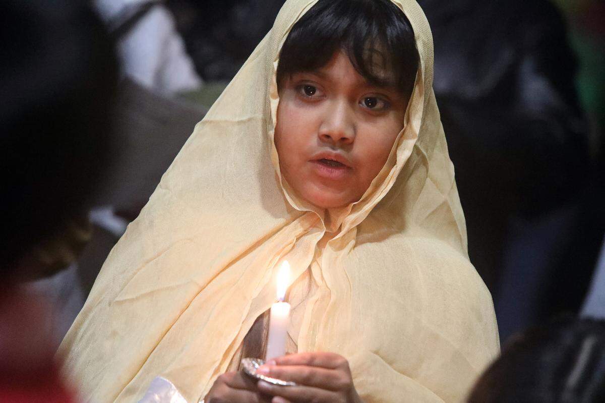 A girl takes part in a posada organized at St. Anthony Mary Claret Church in southeast Fresno on Dec. 18, 2023.