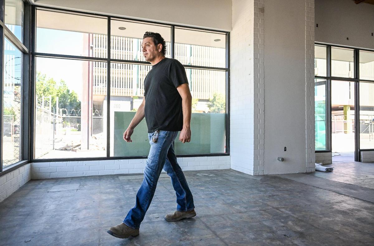 Developer Reza Assemi walks through one of the new units inside The Garage, a five-space retail project at Fulton and Inyo, across from Tioga-Sequoia Brewing, in downtown Fresno.