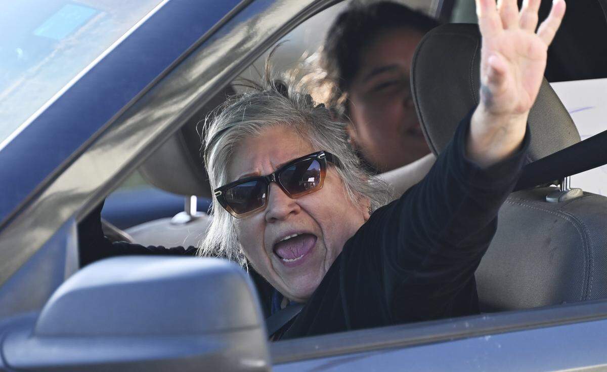 A car passes with its driver and passengers shouting support for Fresno High School students protesting ICE in front of the Fresno Unified School District offices downtown Friday afternoon, Jan. 30, 2026 in Fresno.