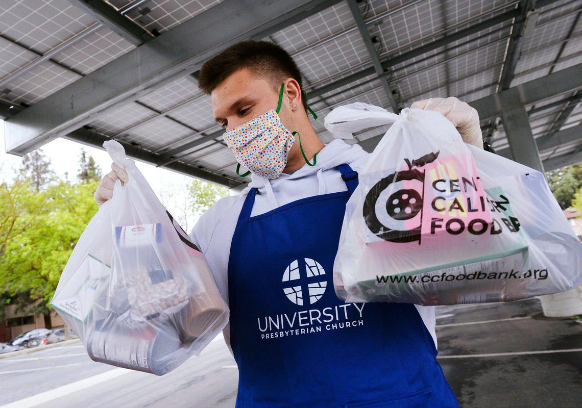 San Joaquin Memorial graduate and University of California, Berkeley’s Zach Angelillo helps distribute food at a giveaway held at University Presbyterian Church of Fresno Saturday morning, April 18, 2020 in Fresno.