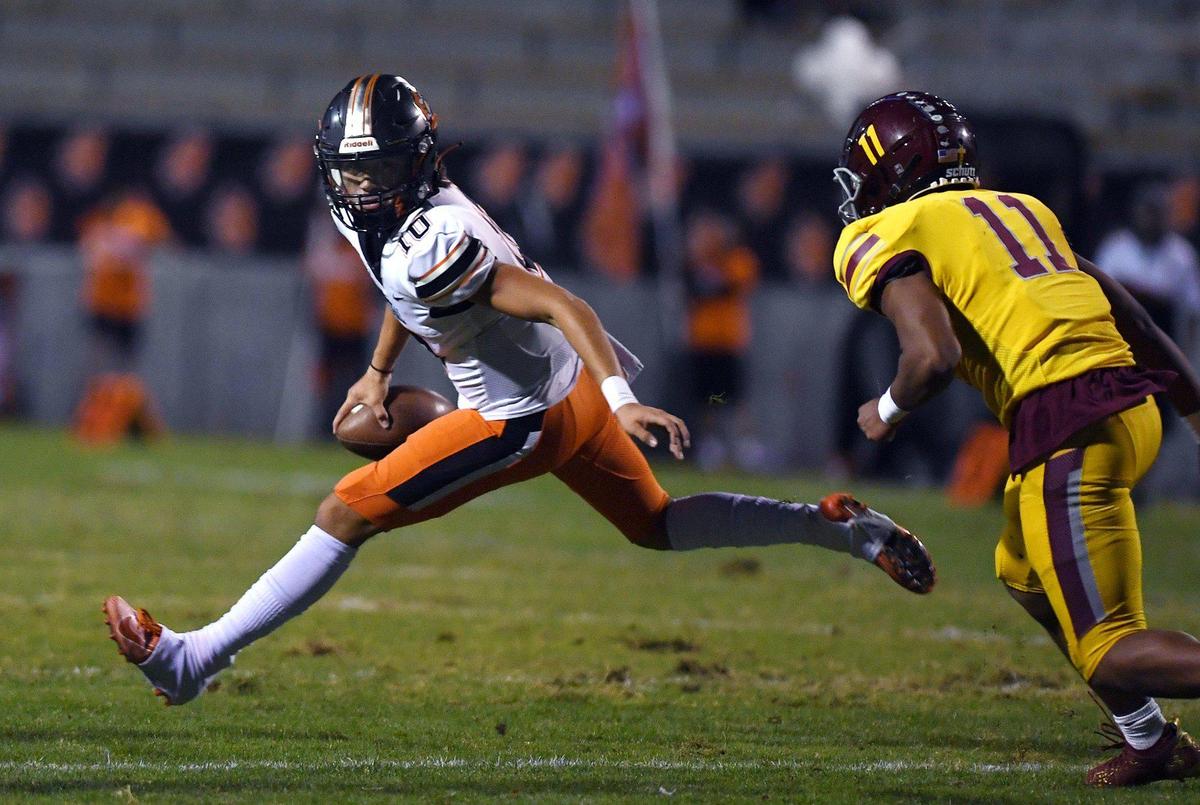 Central quarterback Dayton Tafoya, left, is pressured by Clovis West’s Mychael Crawford, right, in a matchup Thursday, Oct 21, 2021 in Clovis.