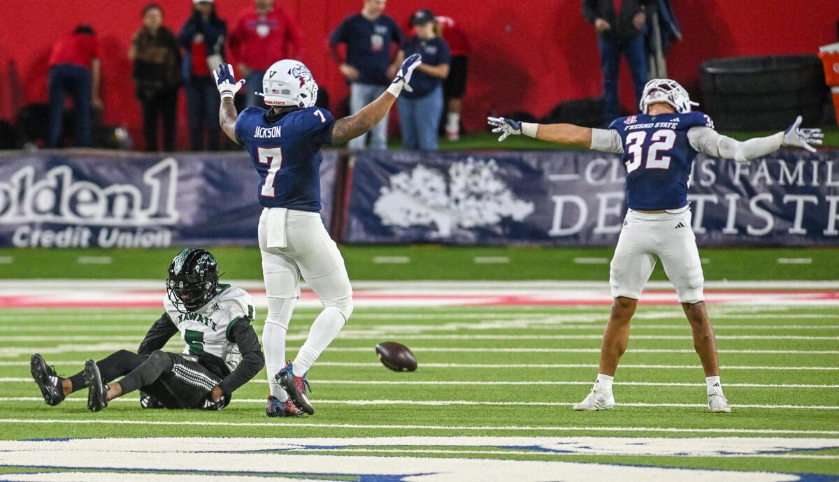Fresno State’s Phoenix Jackson, center, and Dean Clark celebrate breaking up a pass to Hawaii’s Pofele Ashlock during their game at Valley Children’s Stadium in Fresno on Saturday, Nov. 2, 2024.