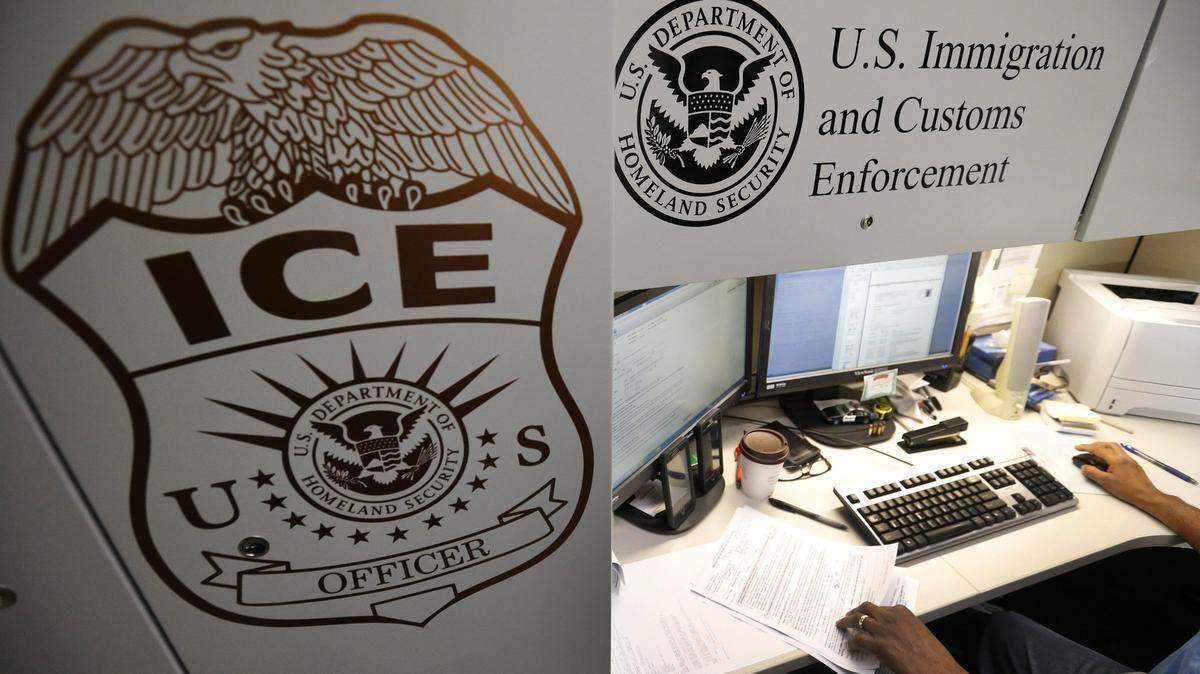 An unidentified Immigration and Customs Enforcement deportation officer reviews forms required to issue a detainer asking local law enforcement to hold someone until ICE agents can pick the person up, at the the Pacific Enforcement Response Center in Laguna Niguel, Calif., on April 26, 2017. (Allen J. Schaben/Los Angeles Times/TNS)
