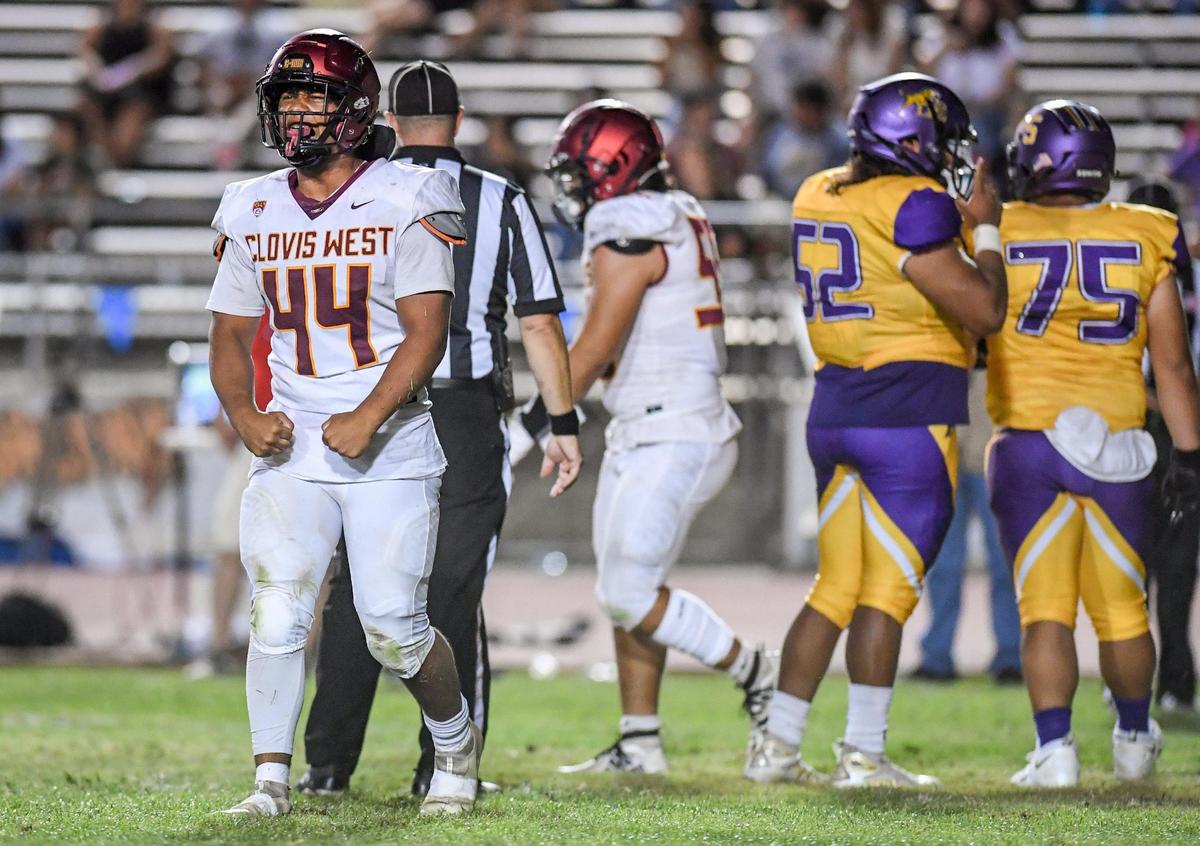 Clovis West’s Brian Evans, left, celebrates a sack against Lemoore in the second half of their game at Lemoore High on Friday, Sept. 2, 2022.