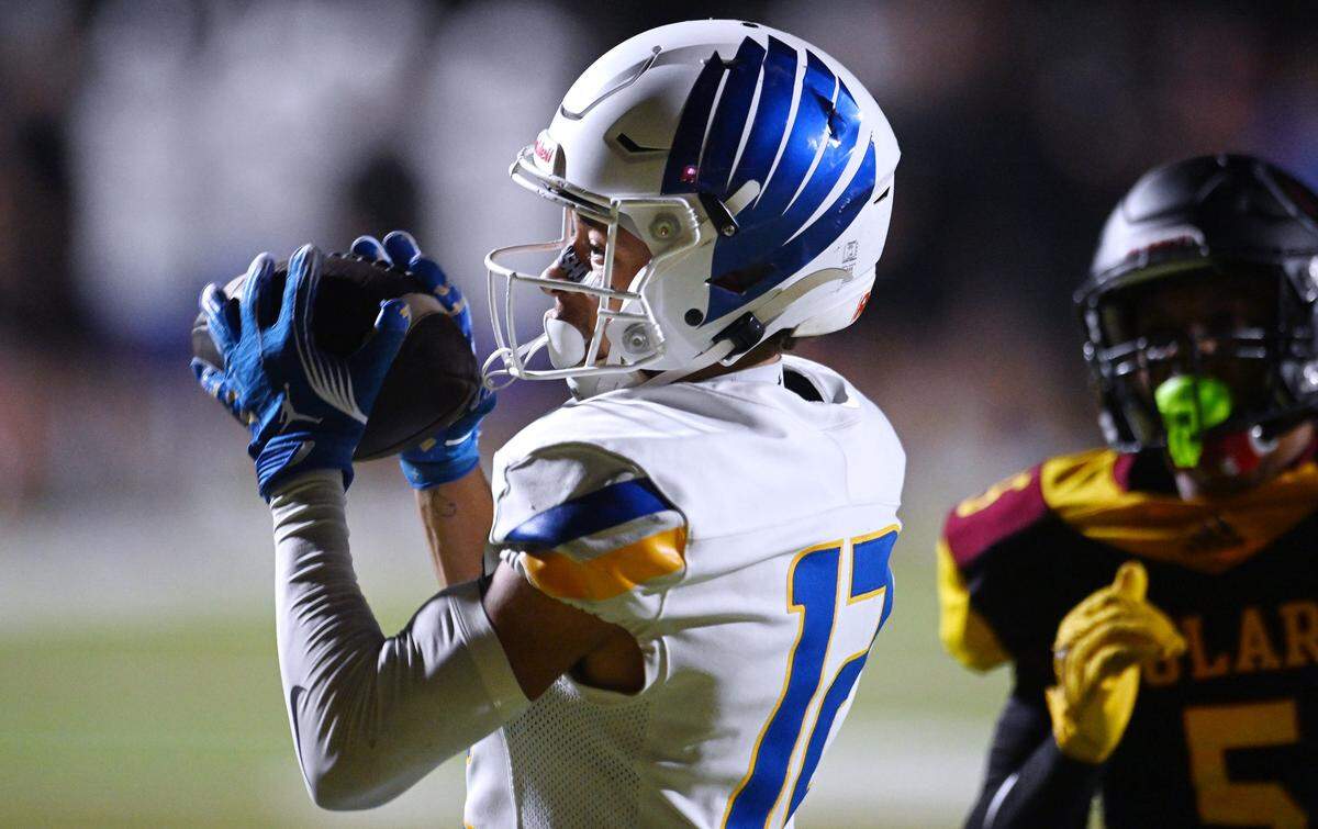 Bakersfield Christian's Michael Smith makes the reception for a touchdown with Tulare Union's Julius Padron to the right Friday, Sept. 26, 2025 in Tulare. Bakersfield Christian beat Tulare Union 30-7.