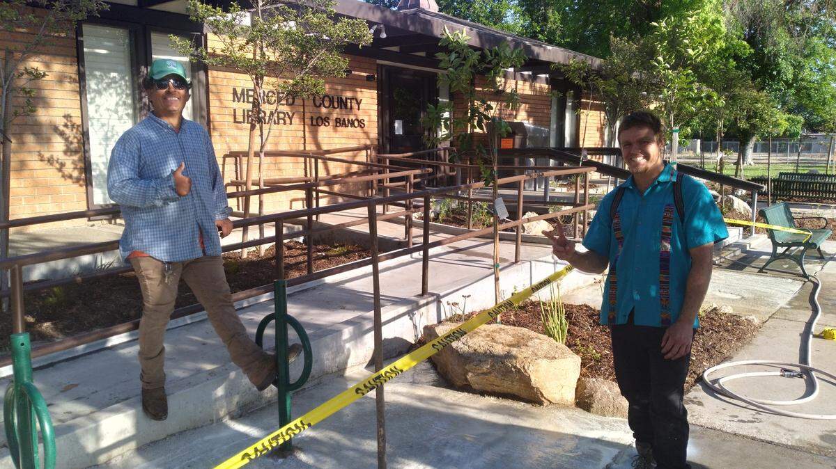 hayne Neuman, right, and Ronny Navarro of Ronny’s Landscaping put the finishing touches of some cement work near the Los Banos Rotary Club’s memorial to Collen Menefee in front of the public library in Los Banos.