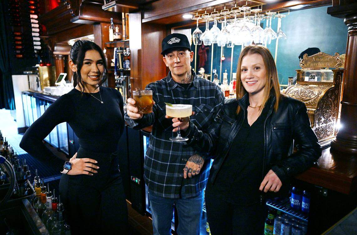 Owner Jason Pistoresi, center, with bartender Alexa Rodriguez, left, and manager/head bartender Andrea Wright, right, pose during a look inside the new Electric Olive cocktail bar in Fresno's Tower District Thursday, Nov. 20, 2025 in Fresno.